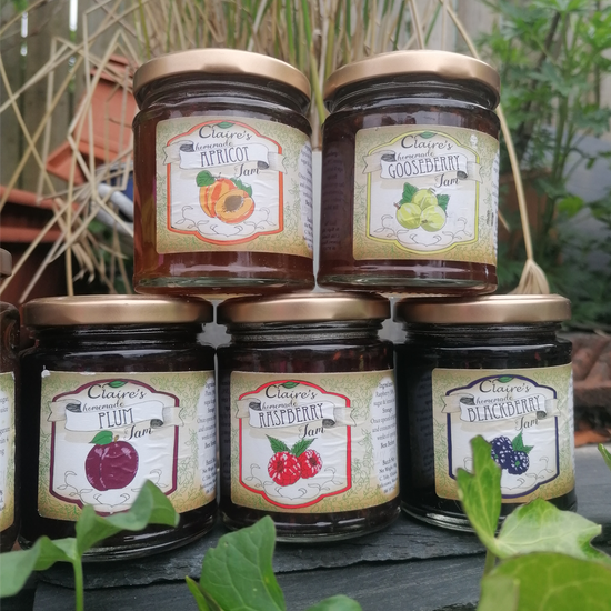 Commission of jam jar labels variety of flavours in an outdoor setting