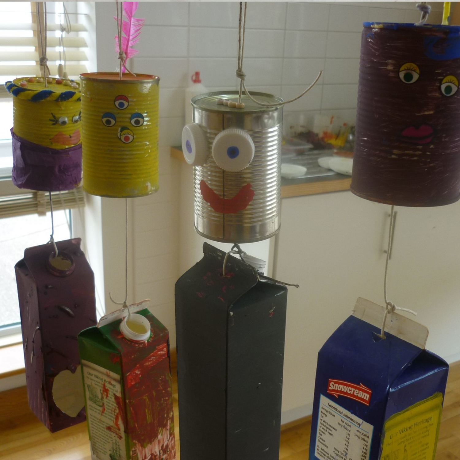 old cans and cartons painted and used to make fun characters during a  Reduce Reuse Recycle Workshop